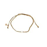 Bracelet doré cordon fin doré avec perle en os