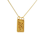 Collier doré plaque texturée serpent oeil en zircon noir 42 cm