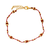 Bracelet doré fil rouge avec coupoles et onyx rouge