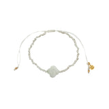 Bracelet doré sur cordon blanc trèfle pierre de lune facettée