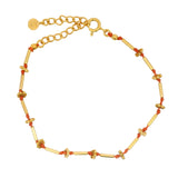 Bracelet tubes cordon et perles dorées