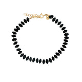 Bracelet doré sur fil avec onyx noire et noeuds blancs