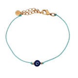 Bracelet doré cordon turquoise avec oeil rond bleu foncé