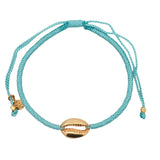 Bracelet sur cordon turquoise avec cauri doré