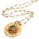 Gold necklace with hammered medal and faceted stone