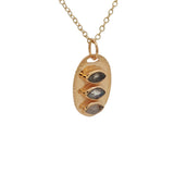 Golden necklace oval pendant trilogy of stones