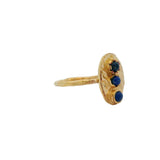 Hammered oval gold ring and trio of stones