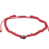 Bracelet doré sur cordon rouge avec petit oeil noir