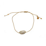 Bracelet tressé doré et coquillage