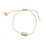 Bracelet tressé doré et coquillage