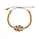 Bracelet cordon disques dorés et coquillage