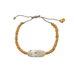 Bracelet cordon disques dorés et coquillage