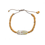 Bracelet cordon disques dorés et coquillage
