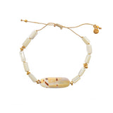 Bracelet cordon doré et coquillage