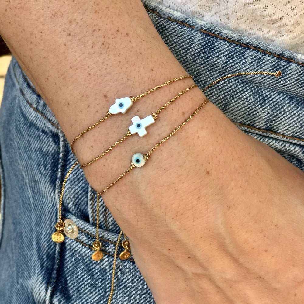 Bracelet tressé doré et croix avec oeil