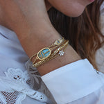 Bracelet doré et oeil martelé et pierre