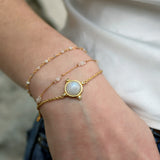 Bracelet doré sphère pierre et 4 zircons