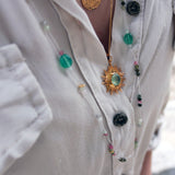 Golden necklace with sun and stone pendant