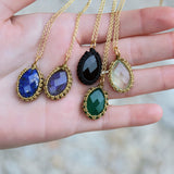 Gold necklace with stone pendant and woven thread