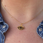 Collier doré et oeil pierre et zircons