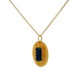 Gold necklace with textured oval pendant and stone
