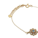Gold bracelet with flower, stone and zircons