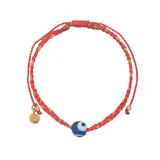 Bracelet sur cordon rouge avec oeil bleu en verre soufflé