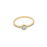 Golden ring with round stone and zircons