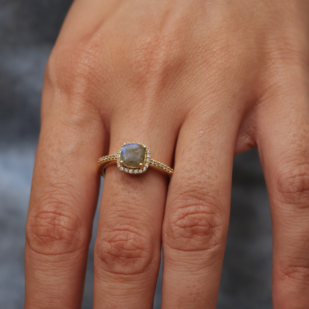 Golden solitaire ring with zircons and square stone