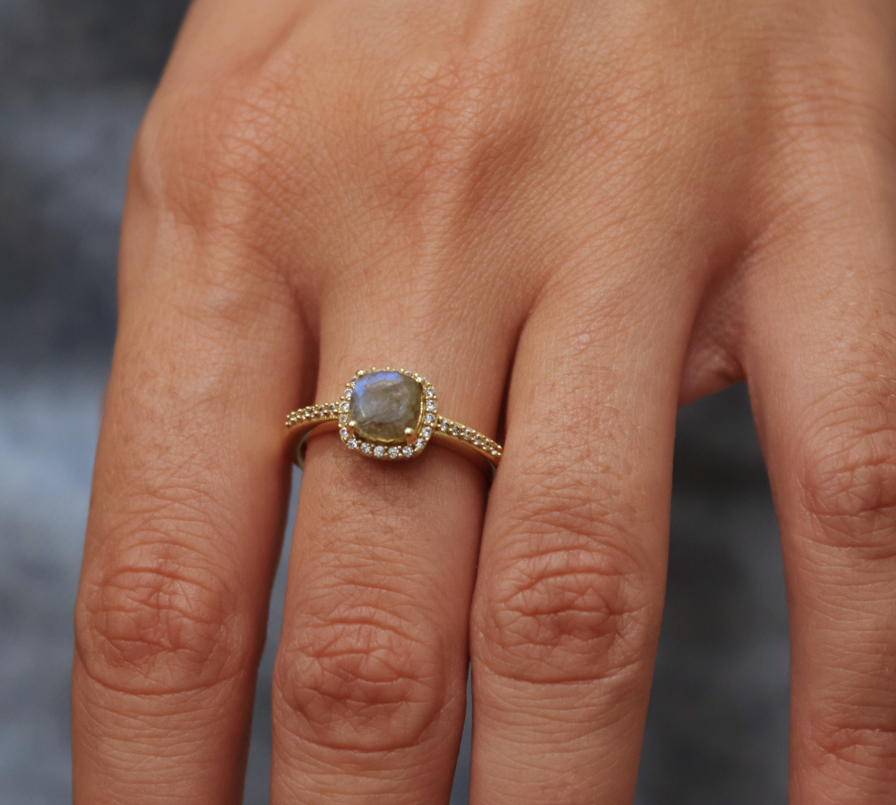 Golden solitaire ring with zircons and square stone