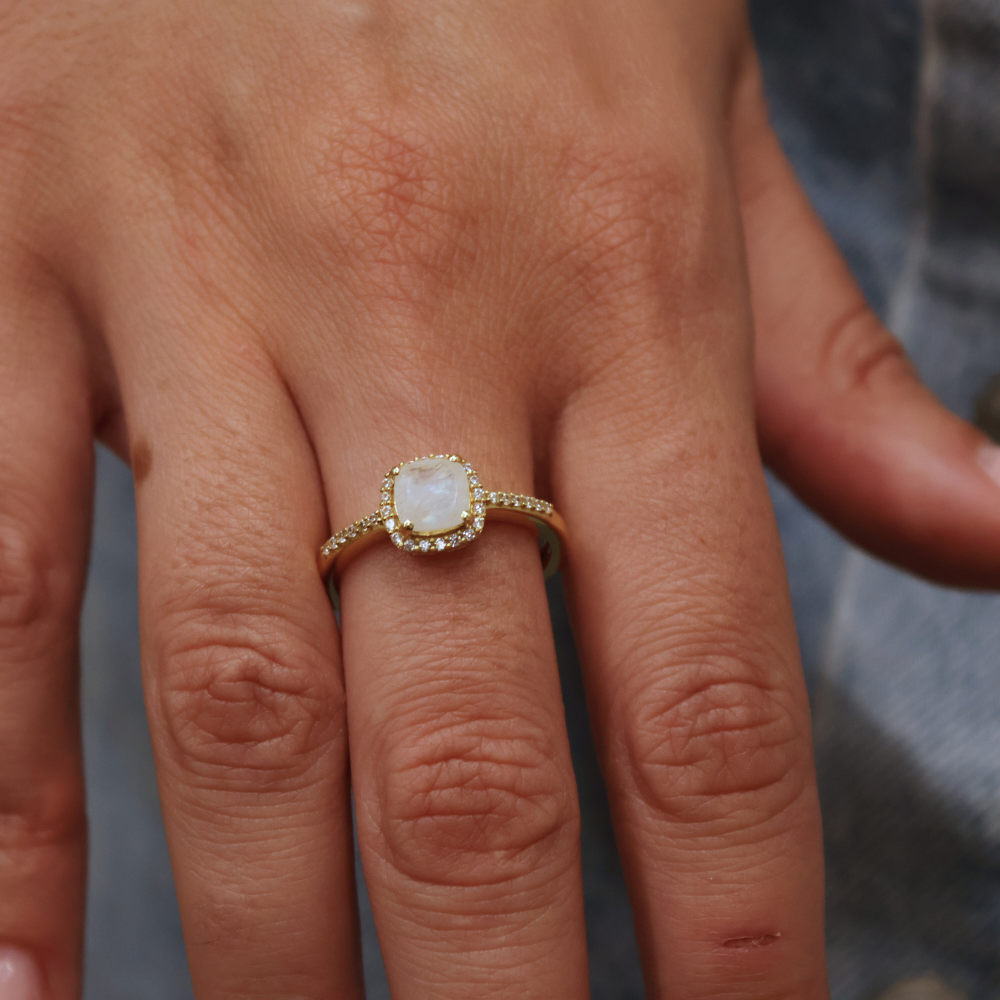 Golden solitaire ring with zircons and square stone