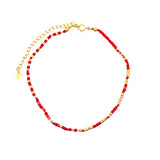 Chaine de cheville dorée et perles rouges et dorées