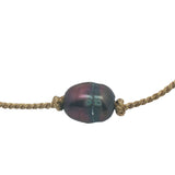 Gold bracelet and gray cultured pearl