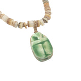 Collier doré disques de coquillage et scarabée vert 68 cm