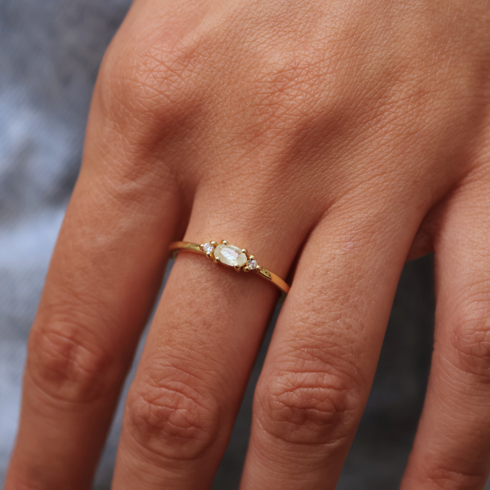 Golden ring with stone and two zircons