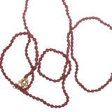 Collier doré petites perles rouges avec noeuds rouges 75 cm