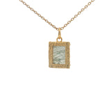 Gold necklace with textured pendant and rectangular stone