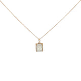 Gold necklace with textured pendant and rectangular stone