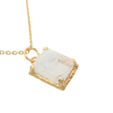Gold necklace with textured pendant and rectangular stone