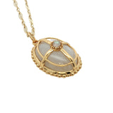 Collier doré pendentif ovale pierre de lune et cage 50 cm