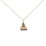 Gold necklace with bell pendant, zircons and stone