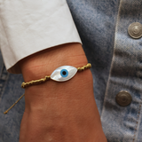 Gold cord bracelet with mother-of-pearl eye