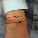 Fine wire bracelet with red and black flat eye