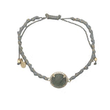 Bracelet doré cordon gris avec labradorite ronde entourée de zircons