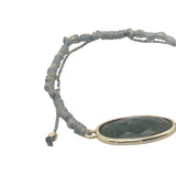Bracelet cordon gris avec labradorite ovale cerclée de doré