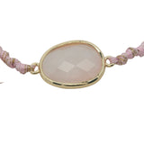 Bracelet cordon rose avec quartz rose ovale cerclé de doré