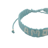Bracelet brésilien doré fil tissé turquoise et crème 'amour"