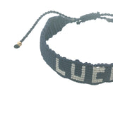 Bracelet brésilien doré fil tissé bleu marine et crème "lucky"