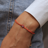 Braided bracelet and flat red eye