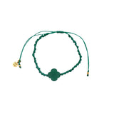 Gold cord bracelet with clover and faceted stone